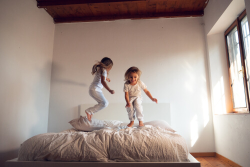 sisters-jumping-on-bed-1.jpg